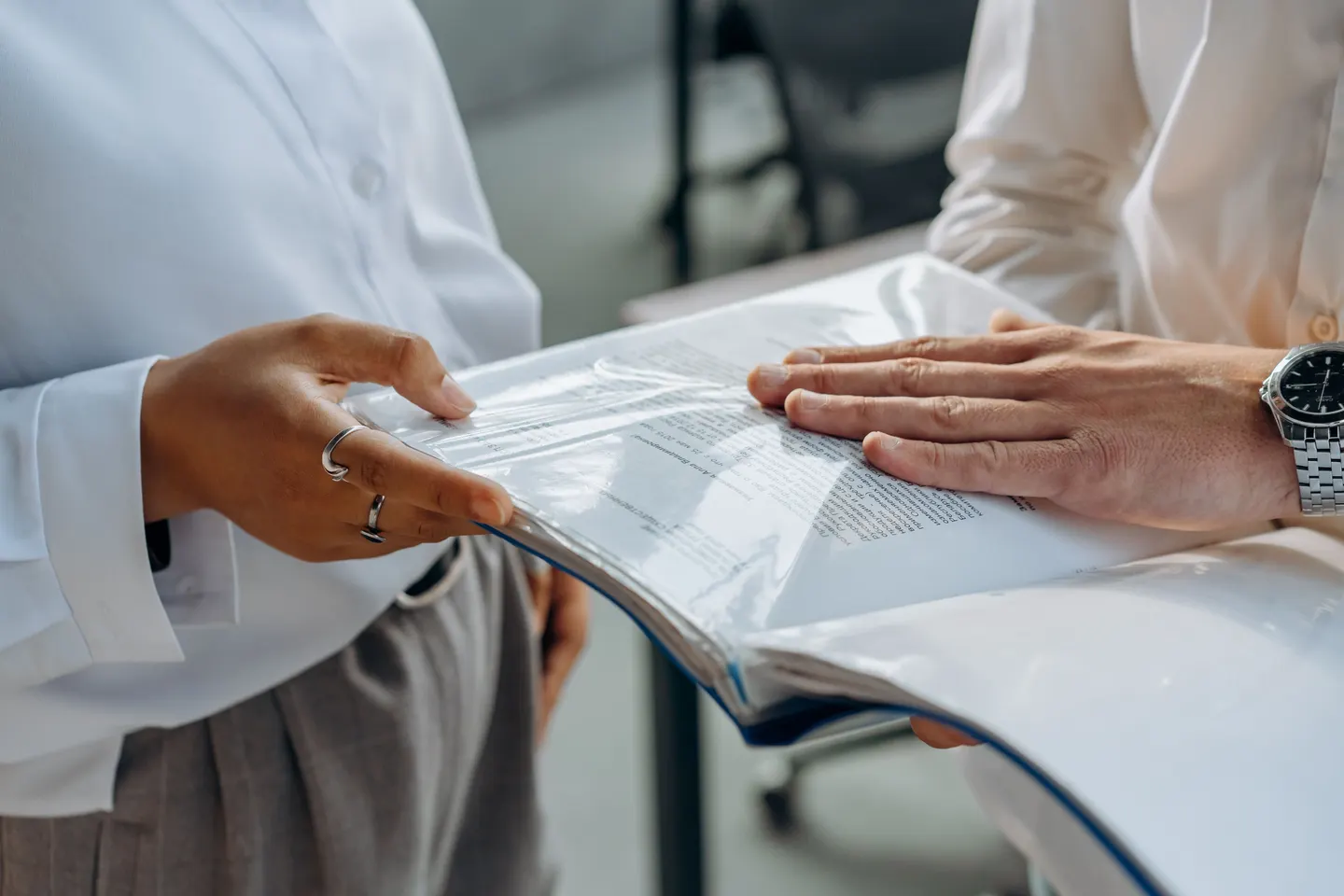 Two colleagues reviewing documents together